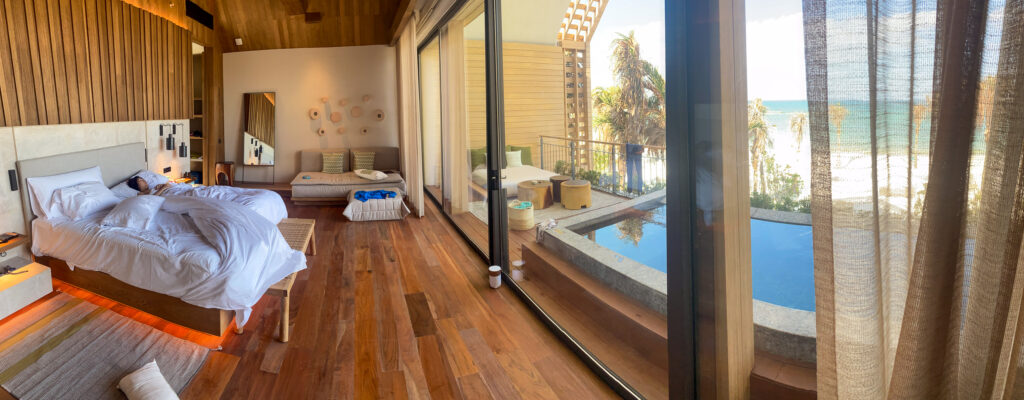 Bed and plunge pool looking out to the Caribbean in a beachfront suite
