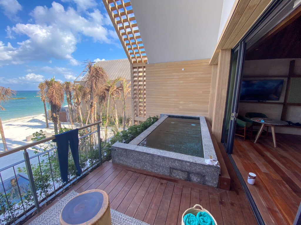 A villa terrace with a private plunge pool above the beach