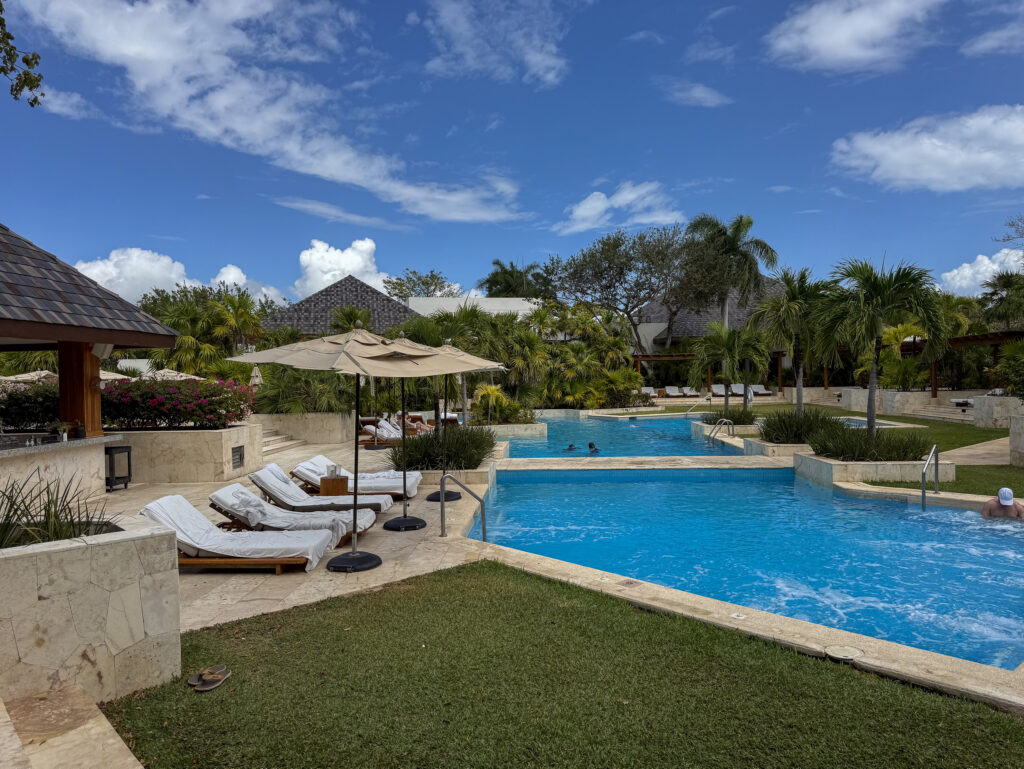 The main pool stepping down in terraces past umbrellas and loungers at Fairmont Mayakoba