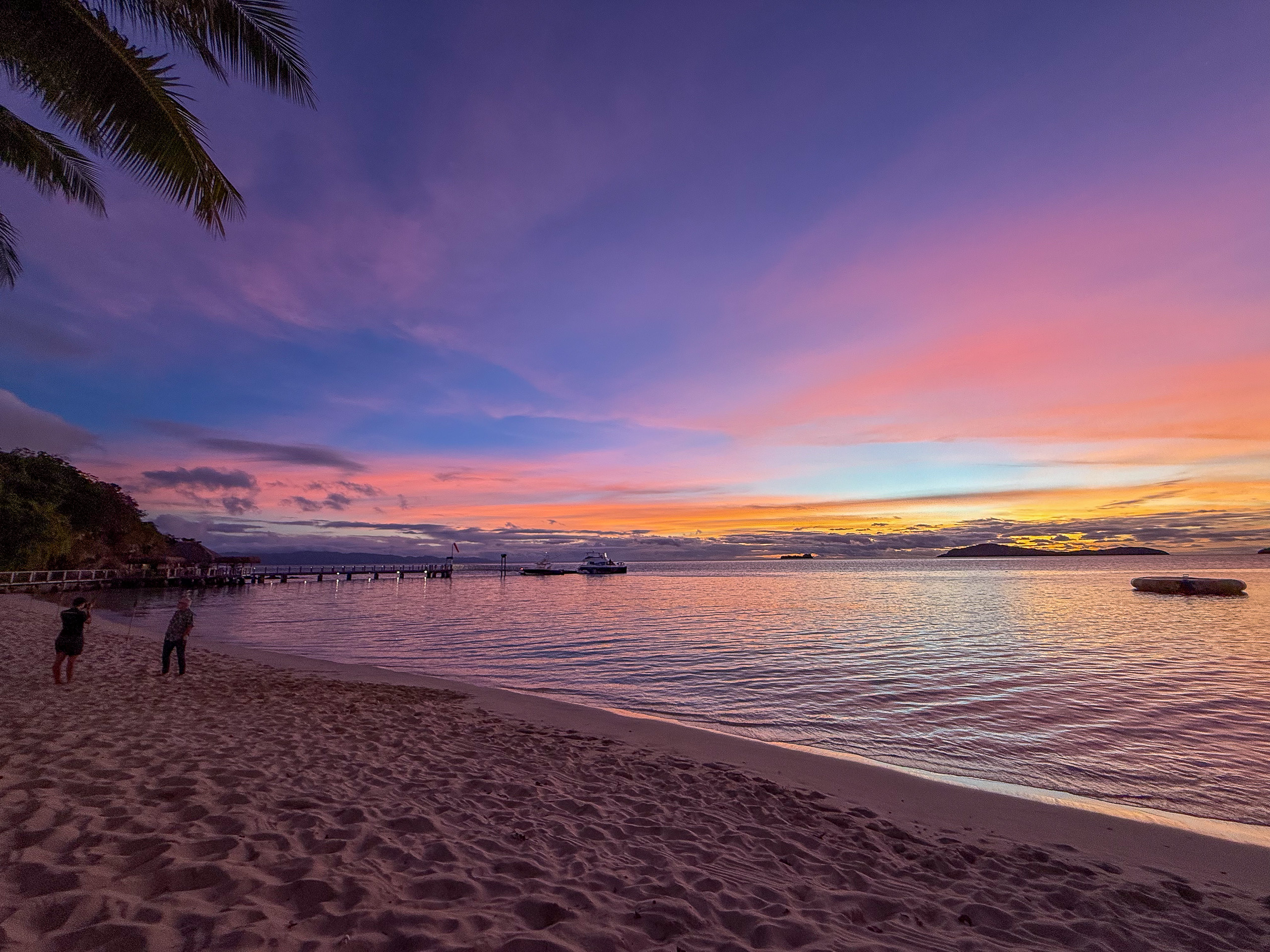 Sunset over the water from the beach at Kokomo Private Island, Fiji