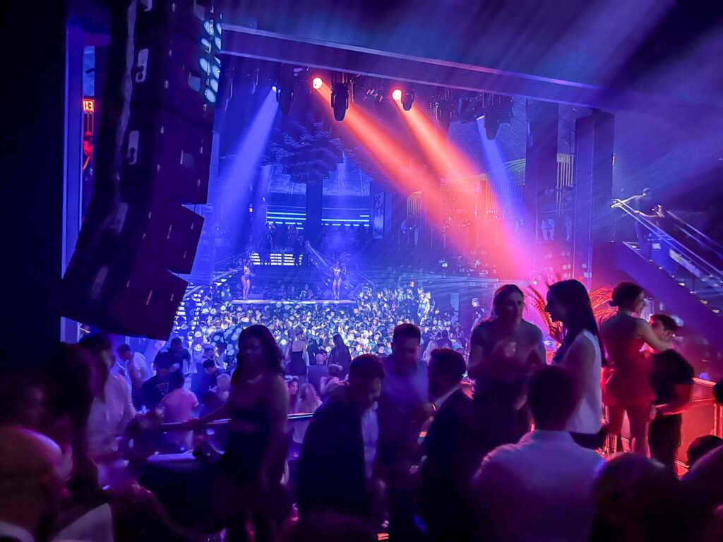 Crowd on the floor of the LIV nightclub under blue and red stage lighting