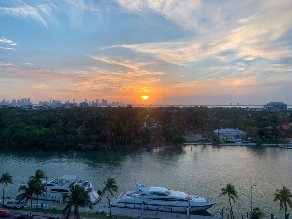 Sunset over Indian Creek and the Miami skyline with yachts moored along the seawall