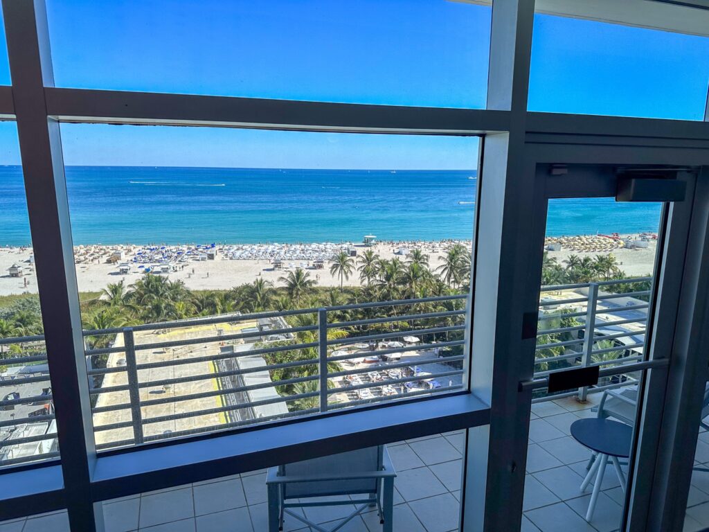 Ocean and beach through the floor to ceiling windows of an oceanfront room
