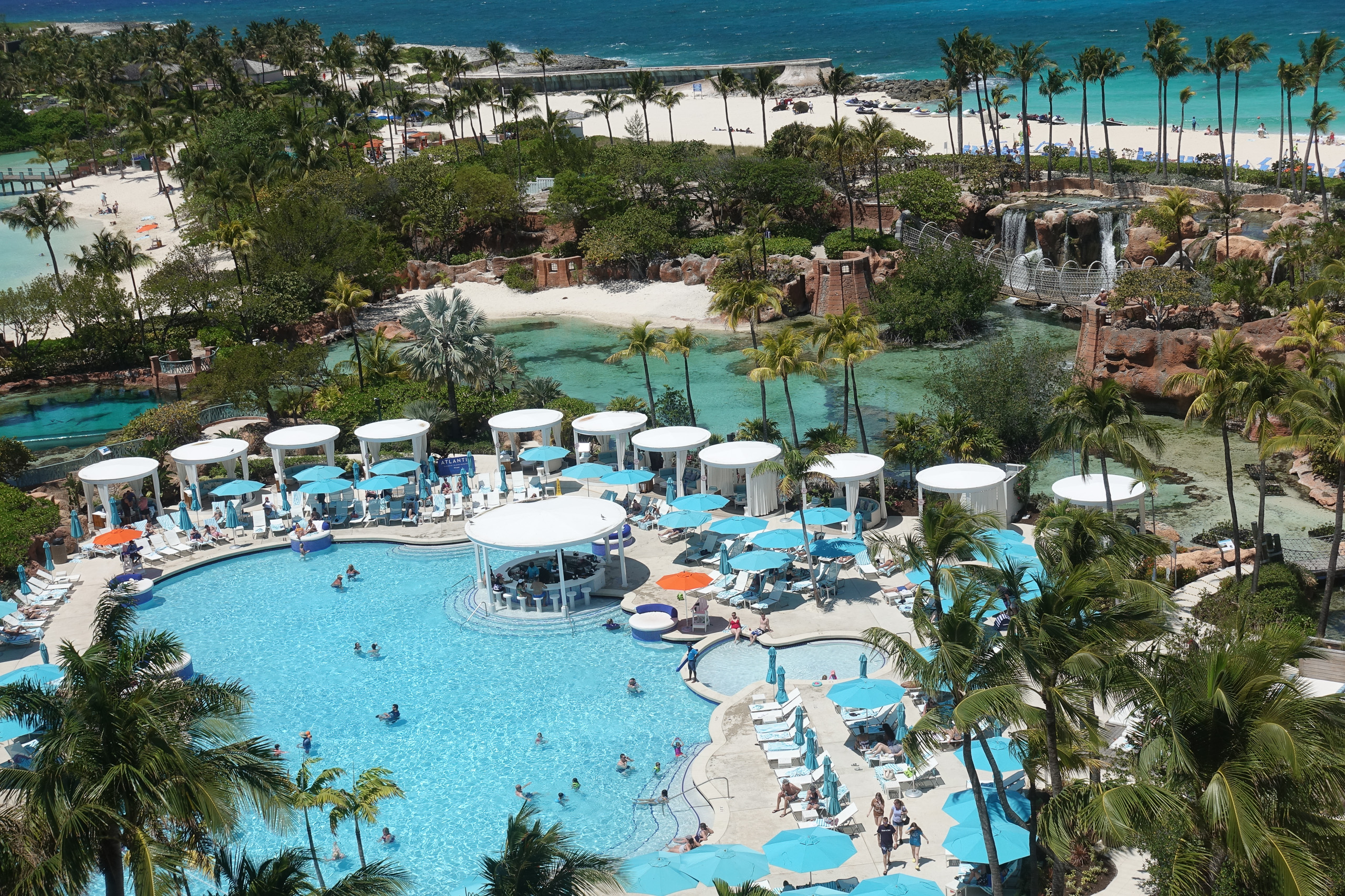 The main pool ringed with cabanas, seen from a high floor
