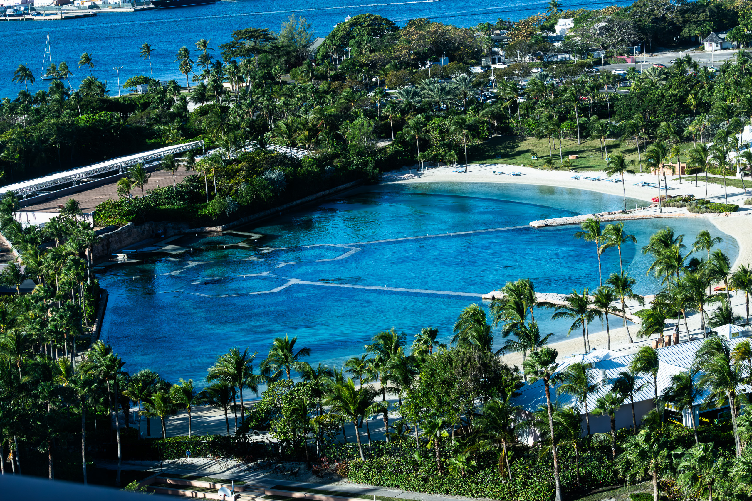 The swimming lagoon curving to the beach, the buoy line drawn across it