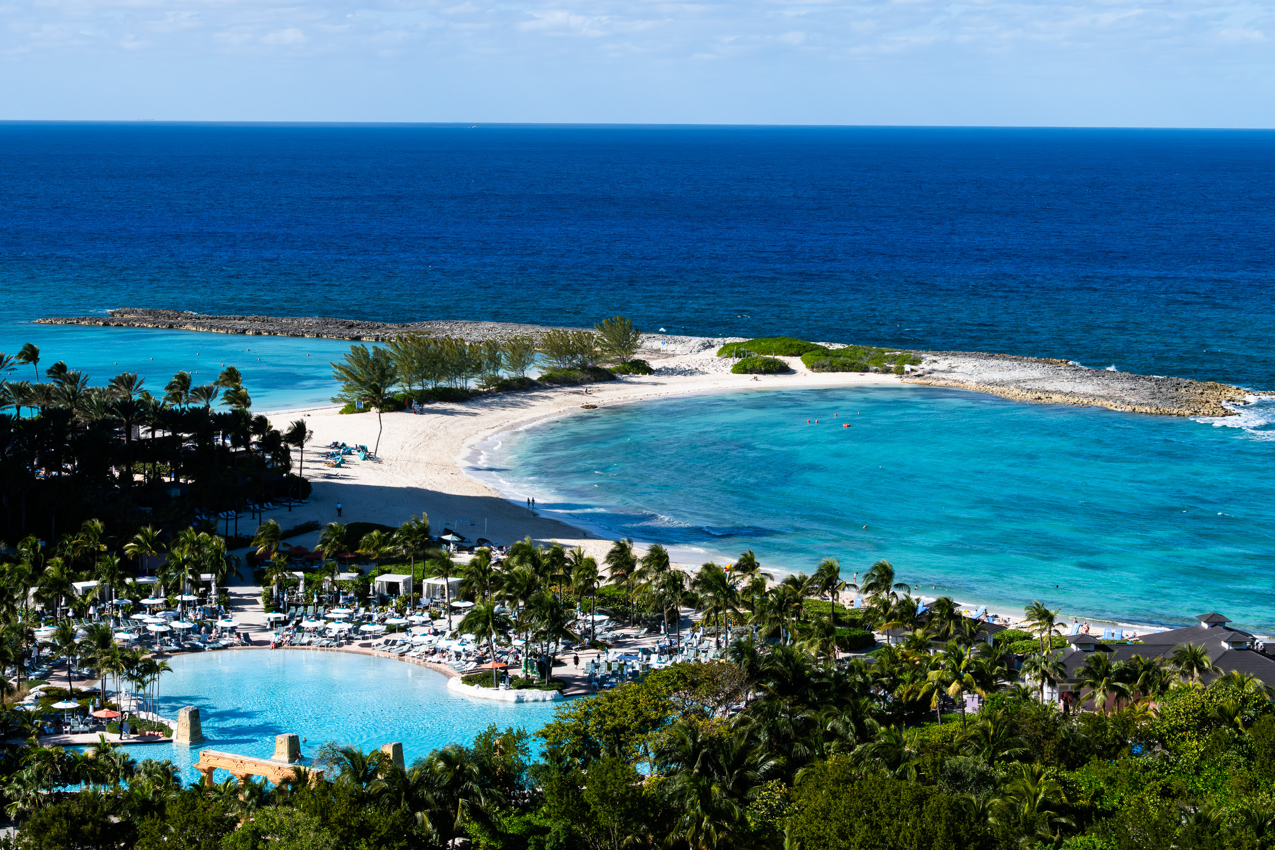 The mouth of the lagoon from above: the spit of beach, then the two blues of the Atlantic