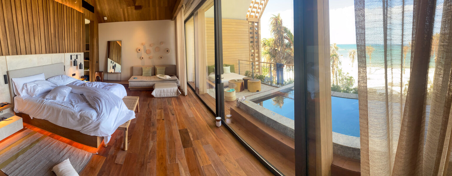 Bed and plunge pool looking out to the Caribbean in a beachfront suite