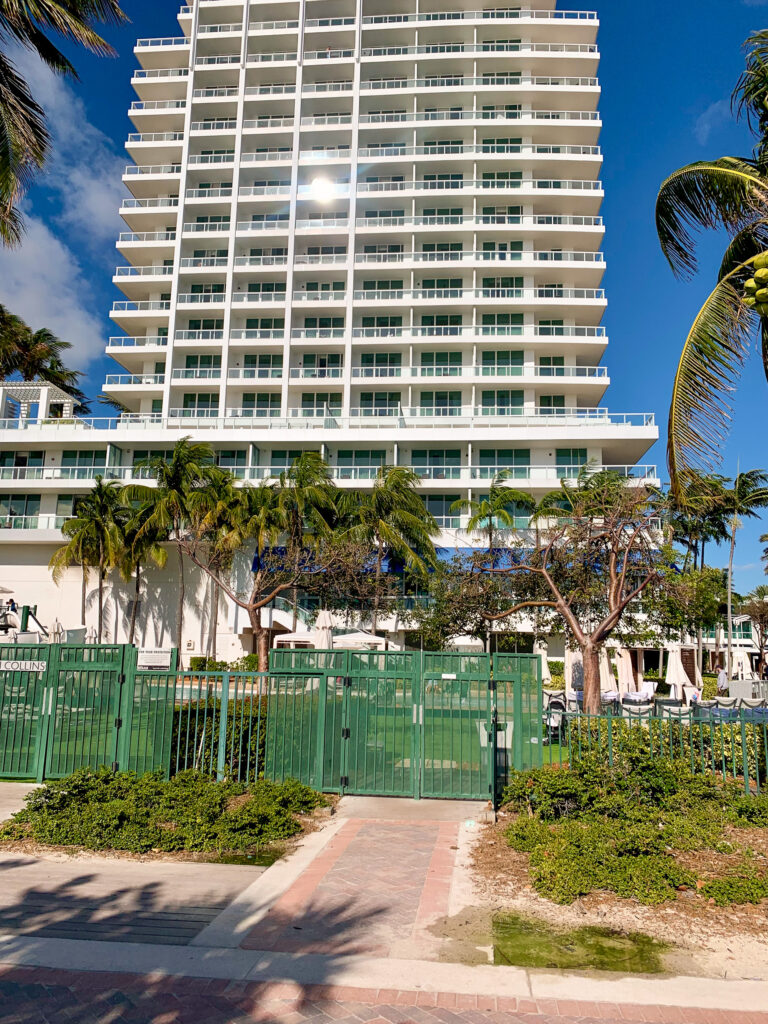 The Fontainebleau tower rising above the palms at the edge of the pool deck