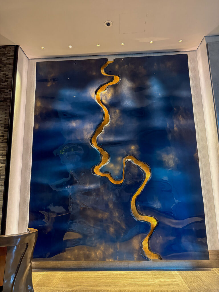 A large blue and gold panel filling the wall, lit from above