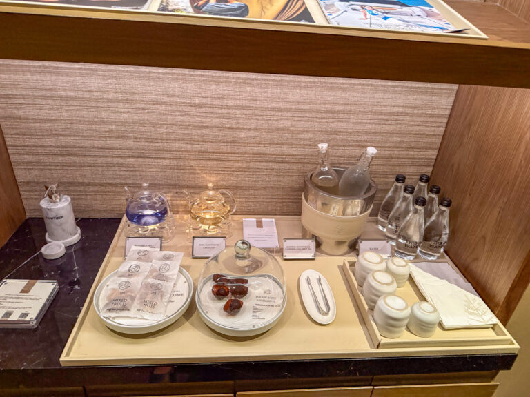 Bottles, dishes and folded cloths laid out along a lit counter