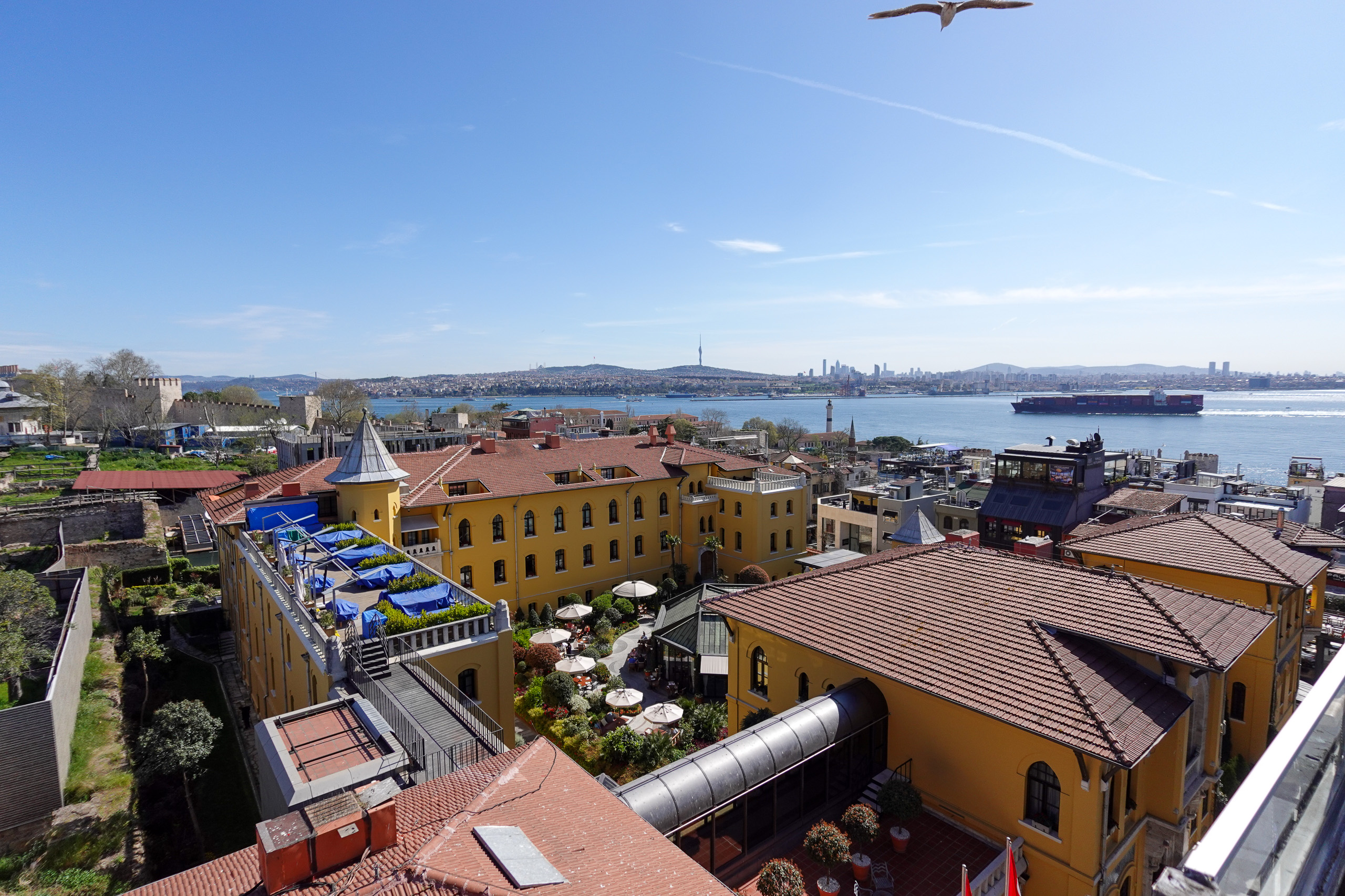 Daylight over the rooftops of the old town, with shipping on the water beyond