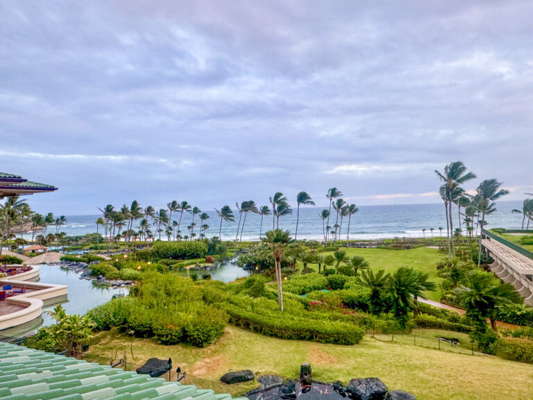 The saltwater lagoons and planted lawns running down to the ocean under grey cloud