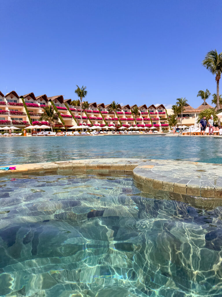 The pool running out toward the water, the resort behind