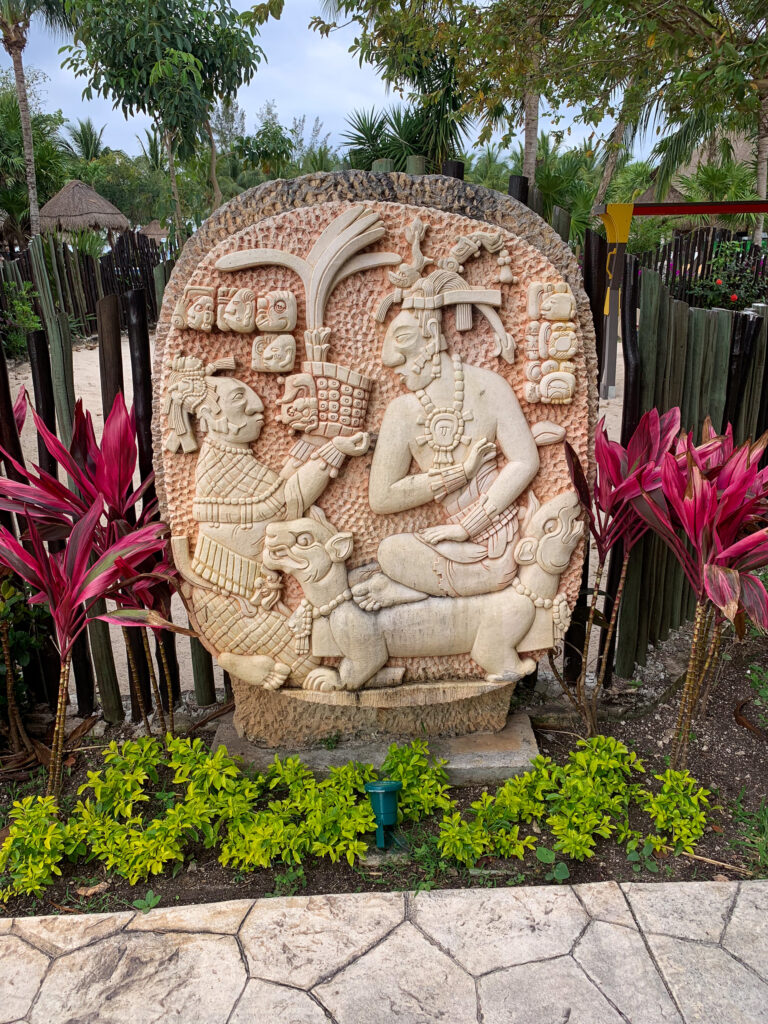 A carved stone relief set among the planting beside the path