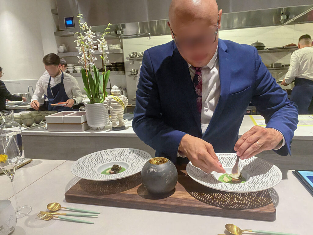 The chef finishing a dish at the counter