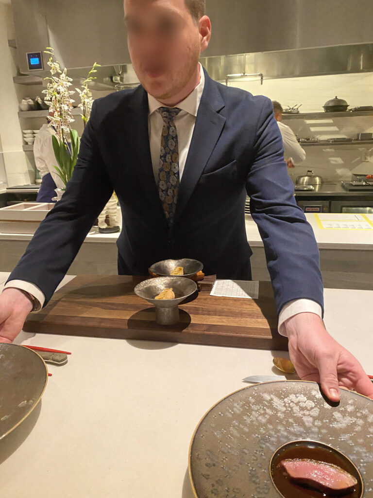 A host presenting a dish at the counter