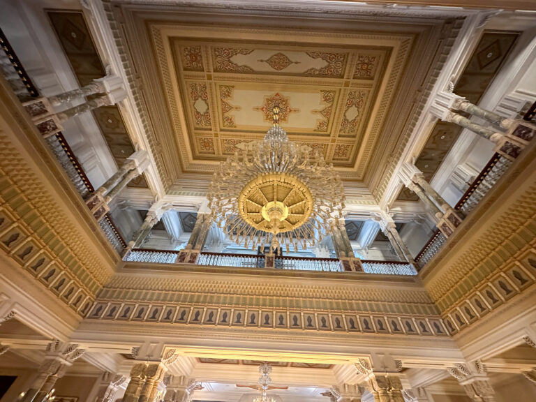 A gilded palace ceiling, the central medallion picked out in gold