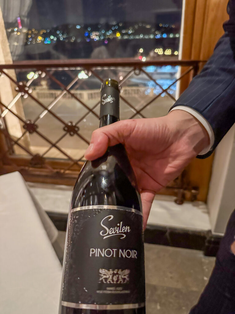 A Pinot Noir presented against the night window