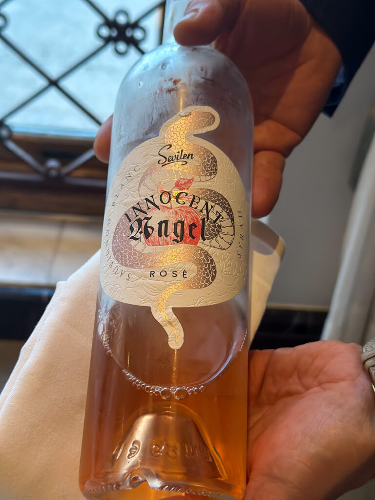 A rosé caught mid-pour at the table