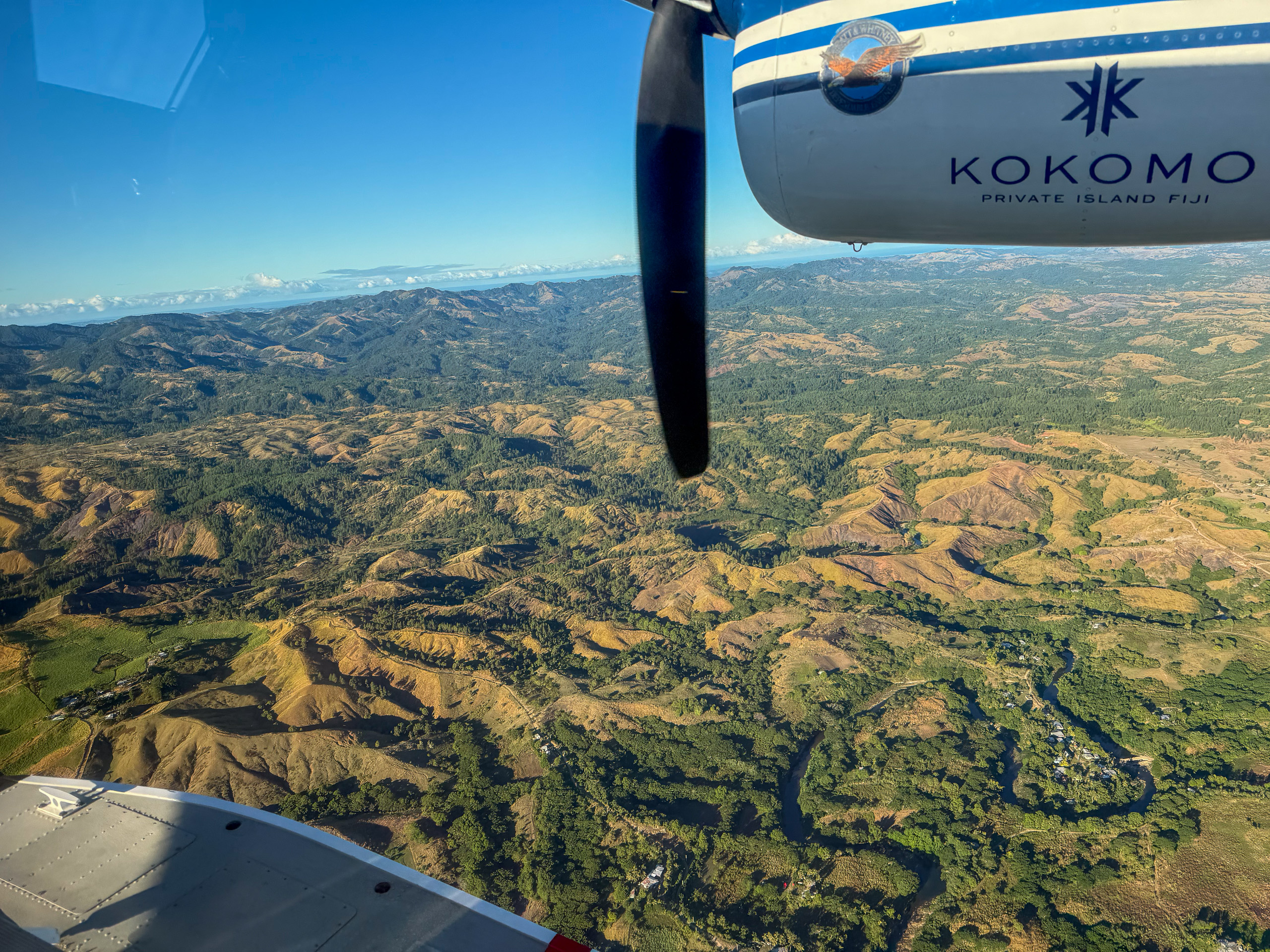 Wing over the green hills on the flight out