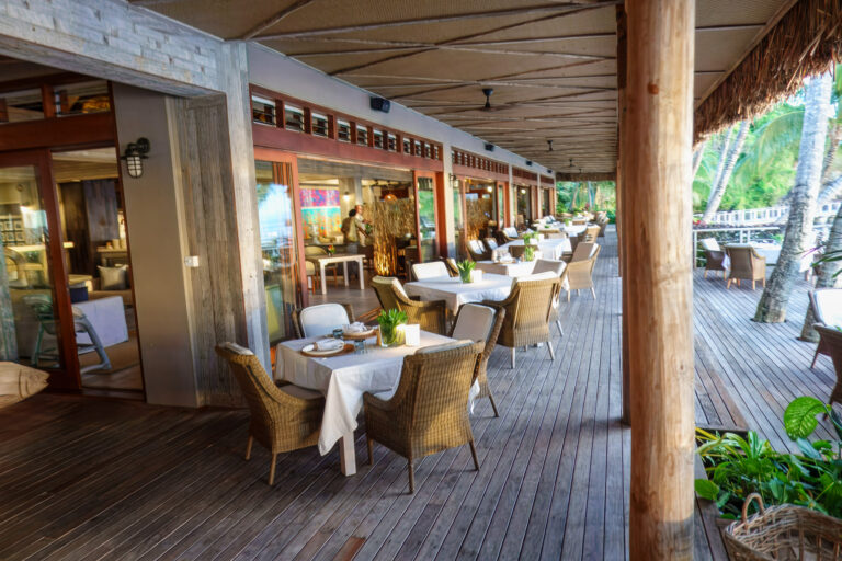 The long dining room, open to the beach