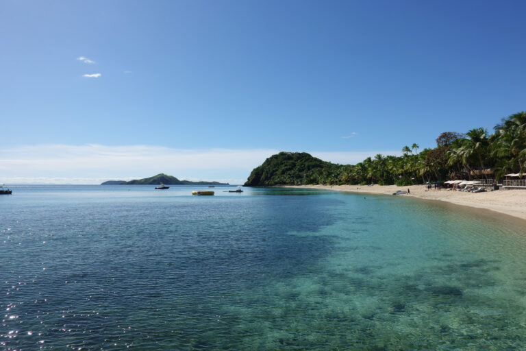 The beach and headland seen from the water