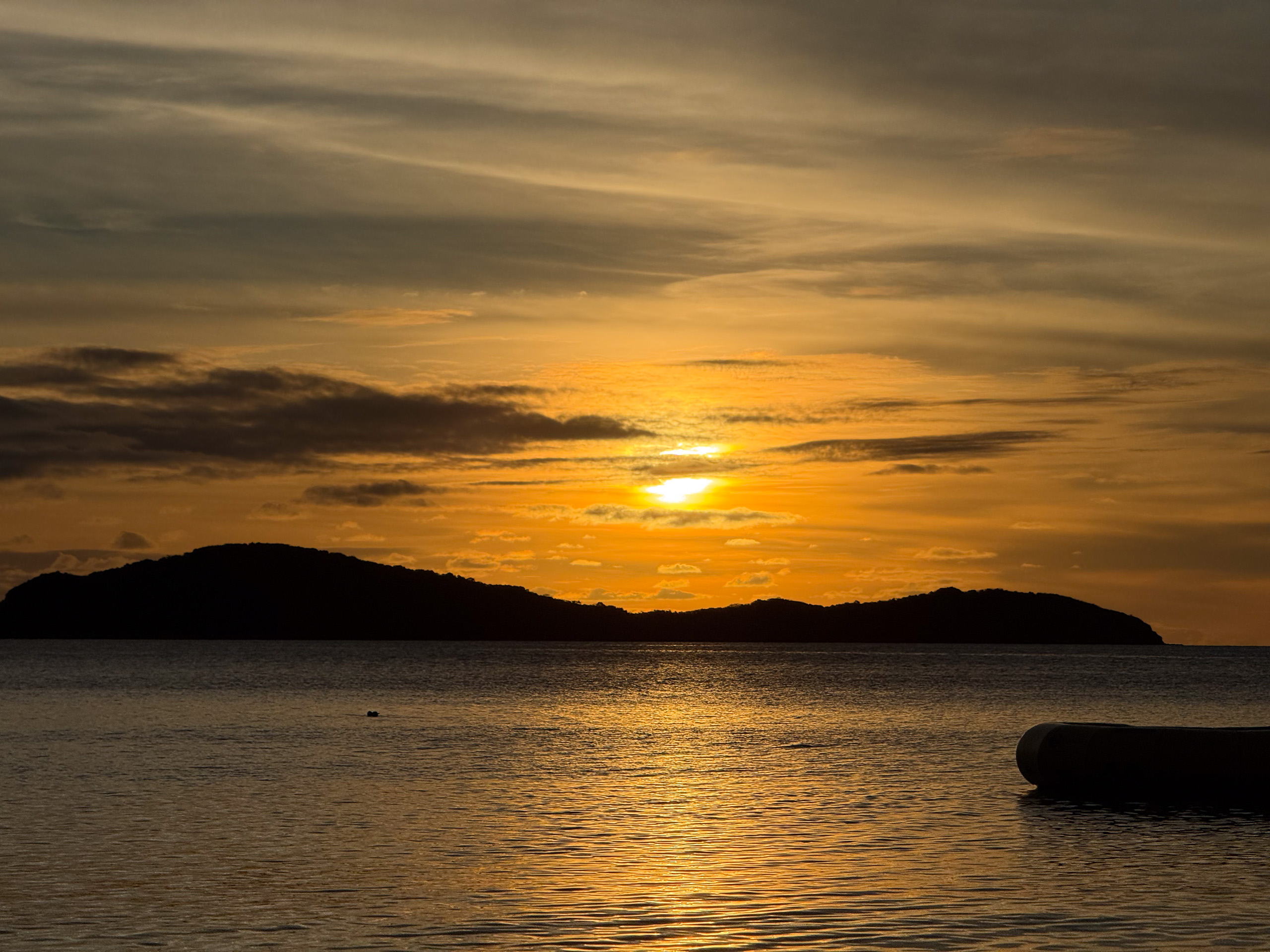 The last of the sun behind the island