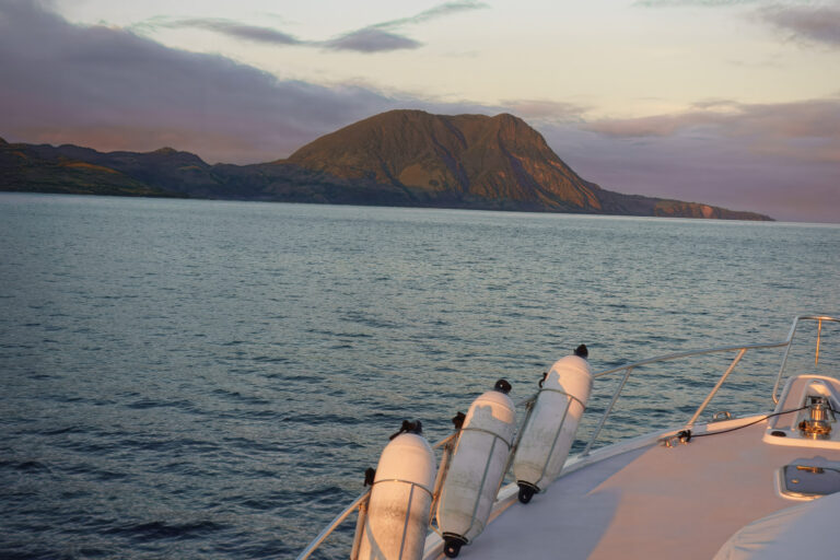 The island astern in the early light on the run to the grounds