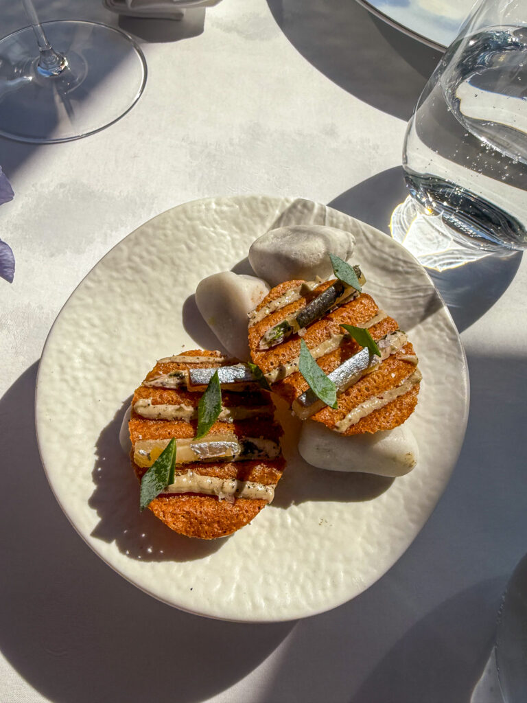 Layered crisp pressed strips with herbs on white china