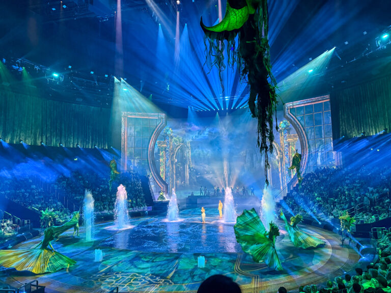 Fountains lit blue and green at the front of the stage