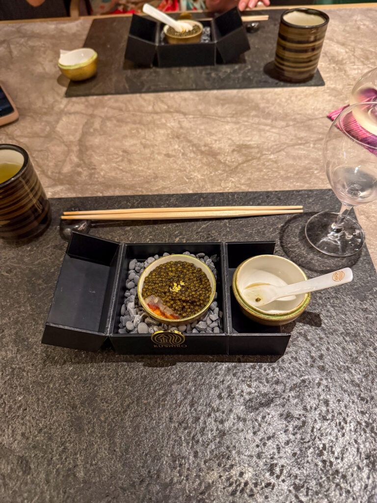 A lacquer tray with caviar and its accompaniments on the stone counter