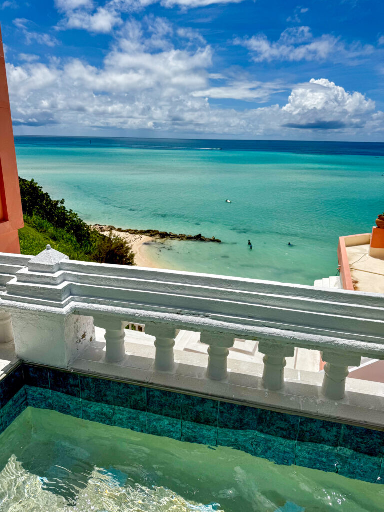 The white balustrade above the beach, the water beyond it