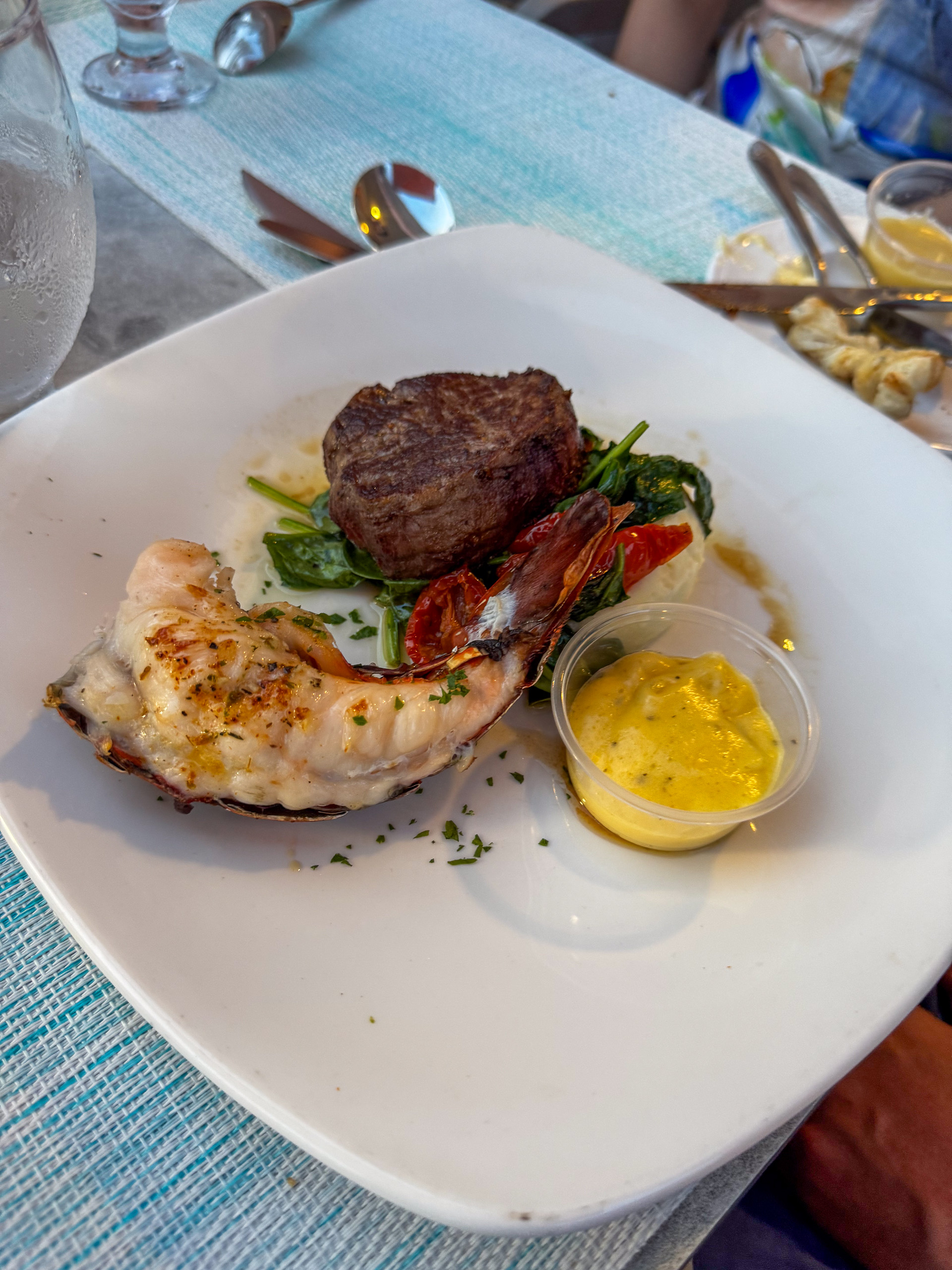 Steak and eggs plated with tomato and greens