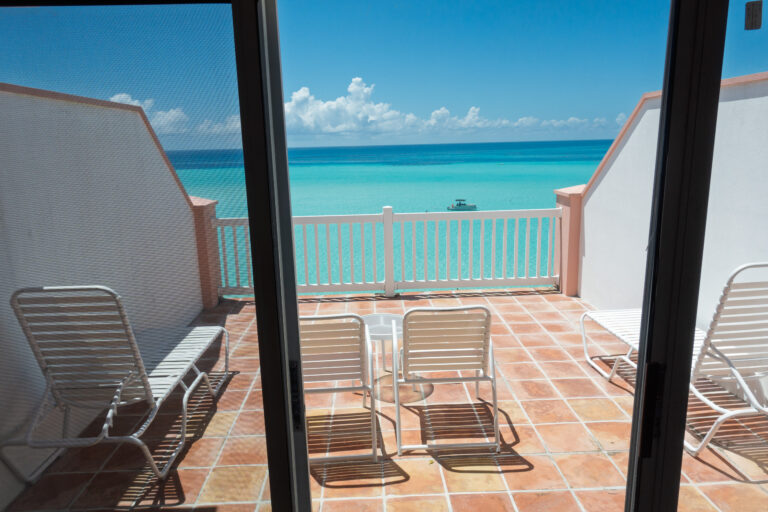 Loungers set out on the brick terrace, the sea framed between the walls