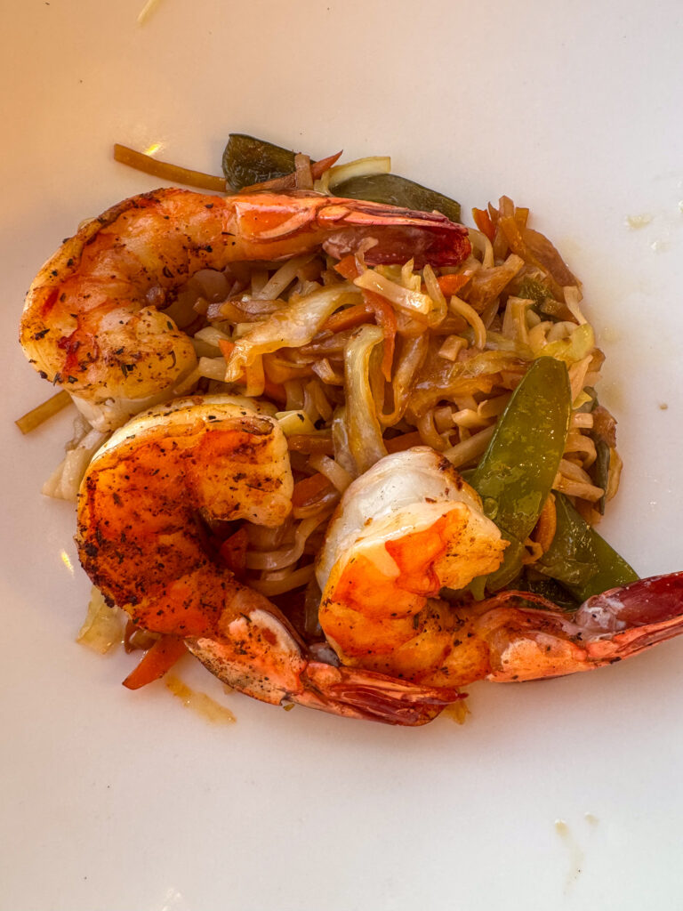 Prawns in a dark sauce, plated hot