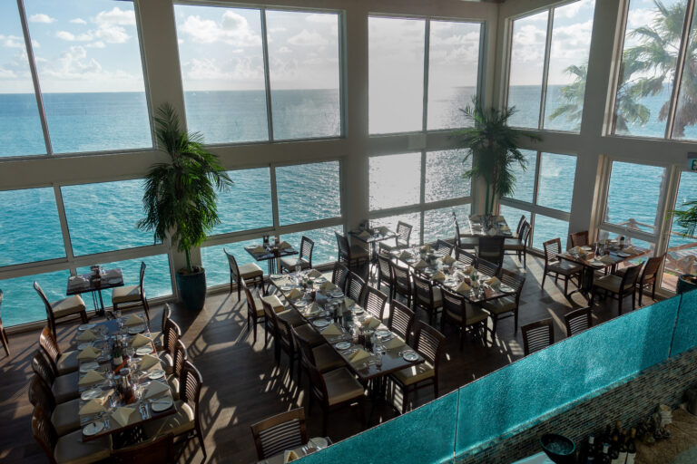 The restaurant laid for dinner, the sea running the length of the windows