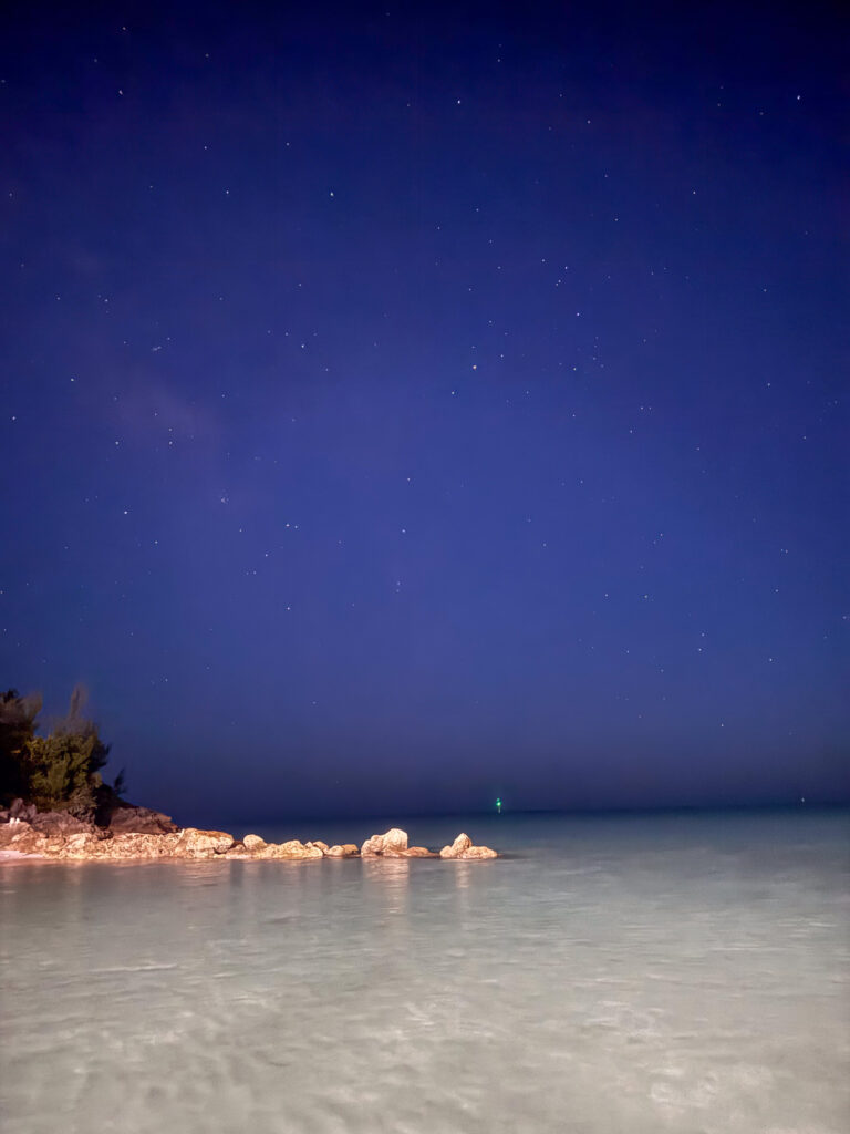 The beach and the water going blue as the light drops