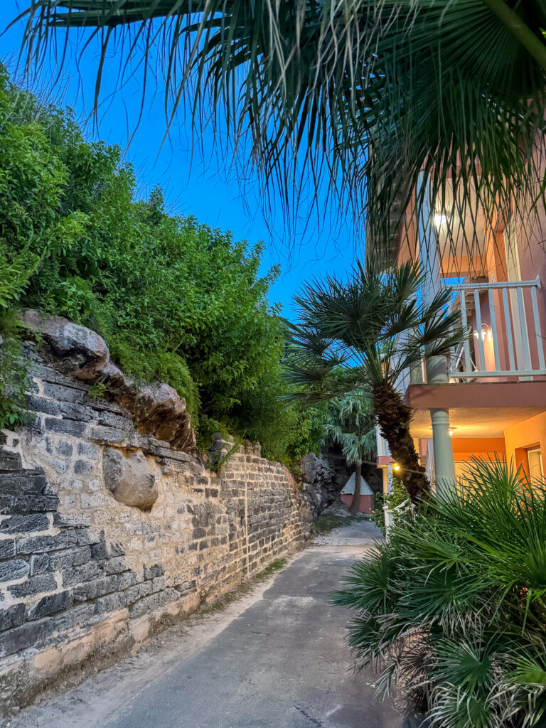 The lit path cut through the rock down to the buildings