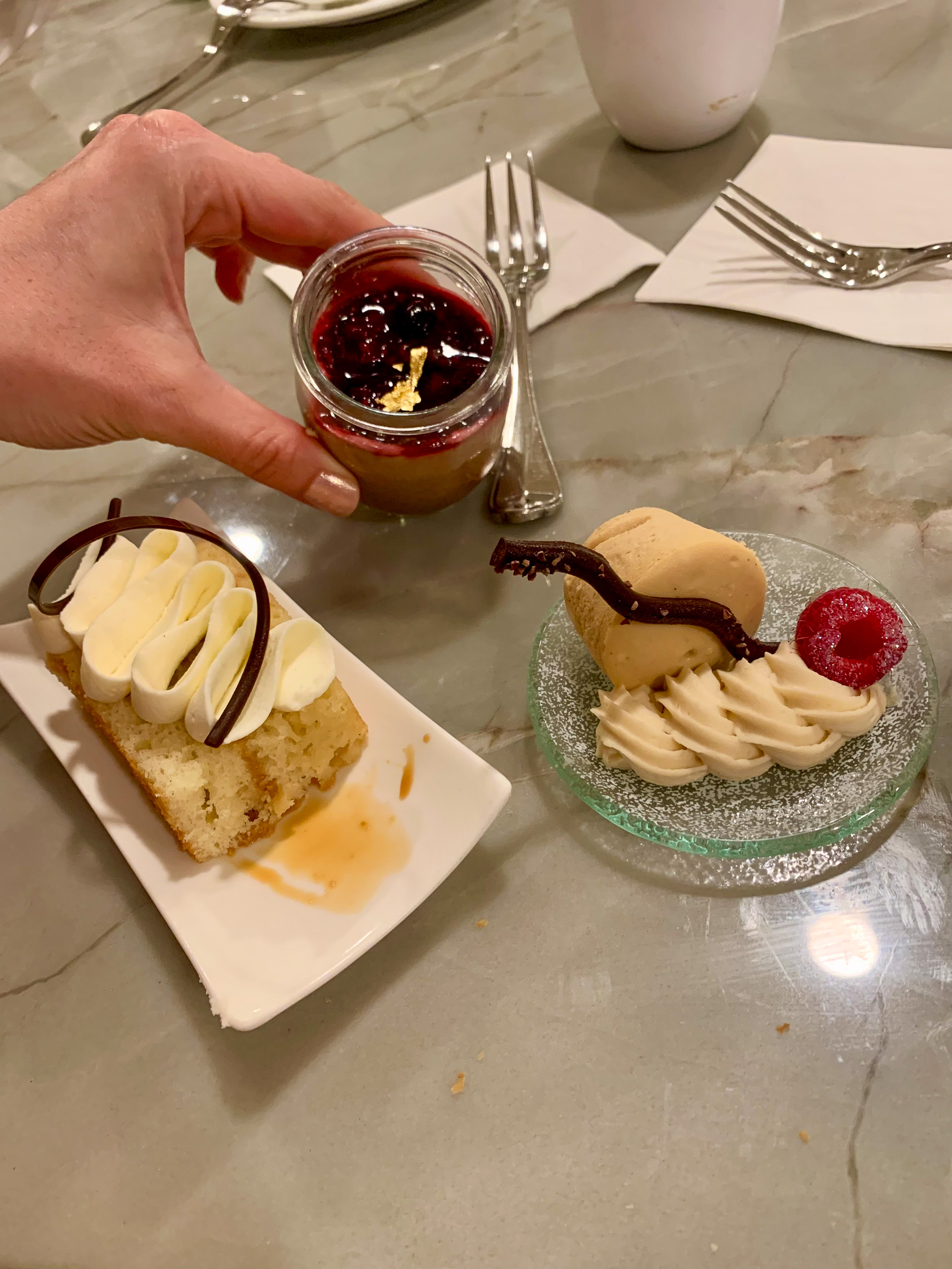 Hot chocolate sauce going over ice cream, the plate finished with a cherry