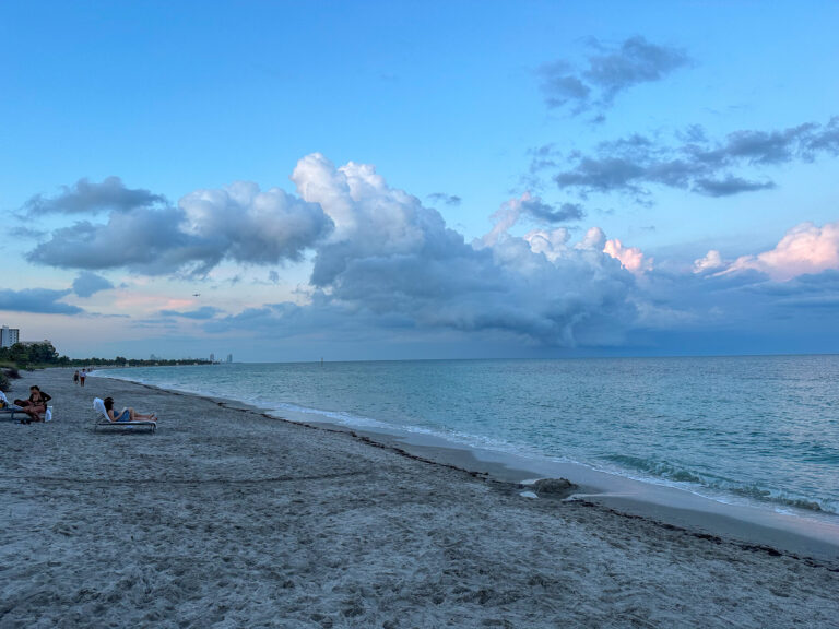The beach under low cloud, the water almost still