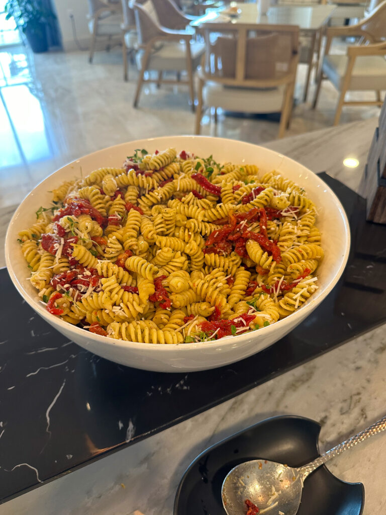 A bowl of fusilli in tomato sauce on the counter