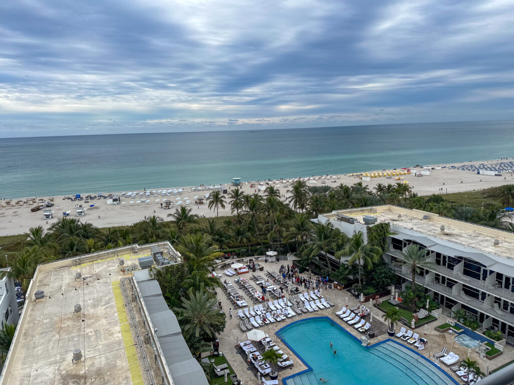 Overhead view of the hotel pool deck and gardens with the beach and ocean beyond