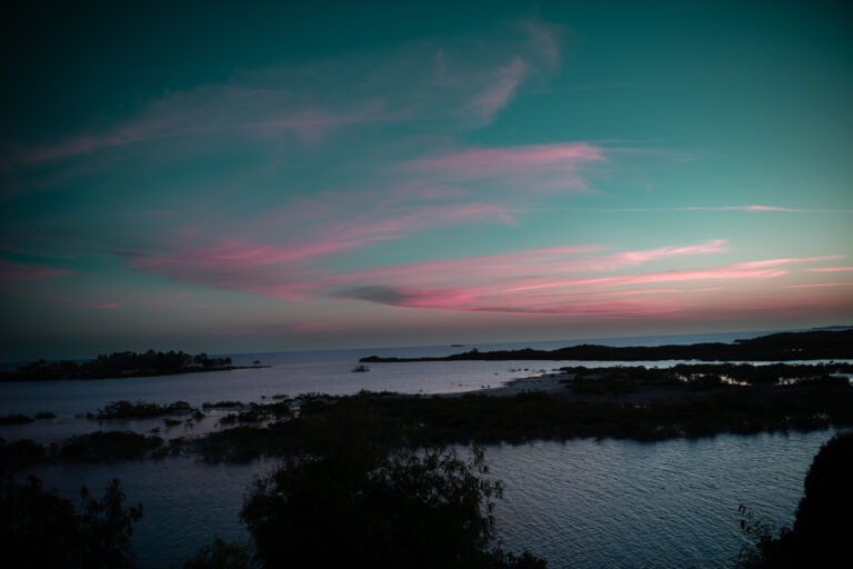 Pink cloud over the flats after sunset, the water gone silver