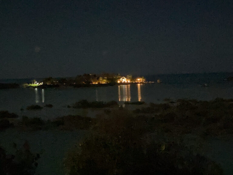 Lights along the far shore reflected across dark water