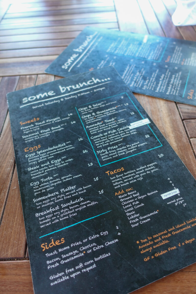 A chalkboard brunch menu propped on the timber table