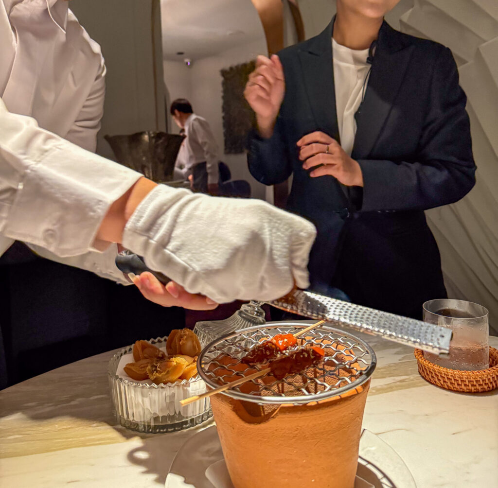 Two of the team finishing a dish at the table