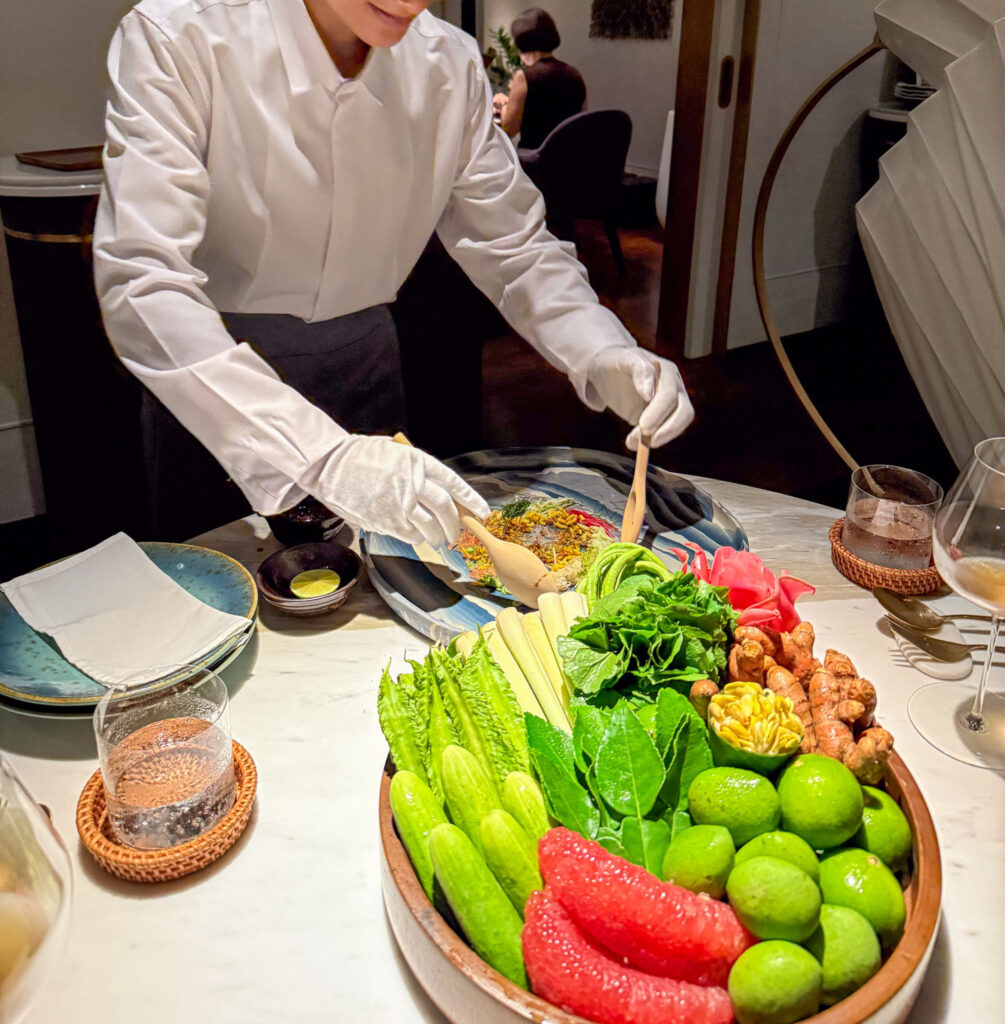 A course finished at the table beside a bowl of raw vegetables