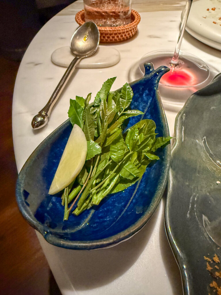 Blanched greens in a deep blue bowl