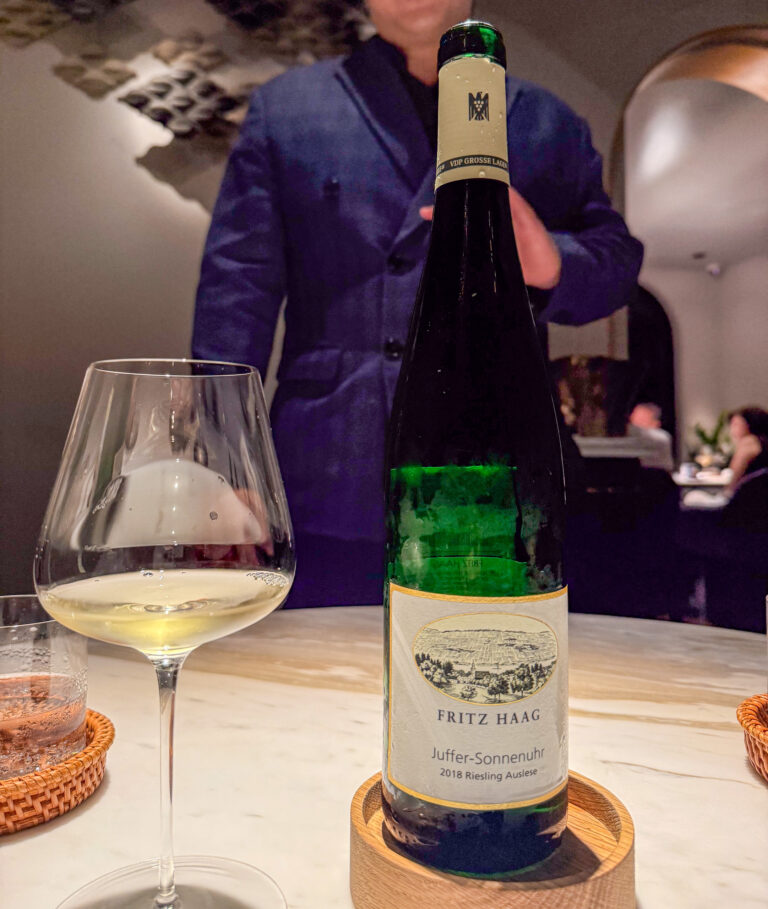 The bottle shown at the table before pouring