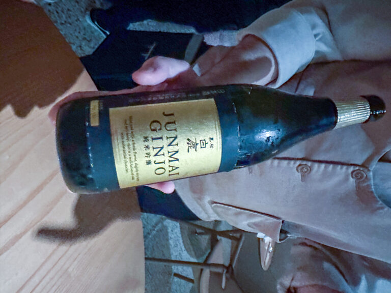 A bottle of junmai ginjo sake presented over the table